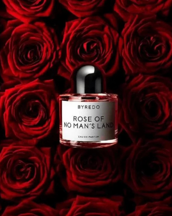 A bouquet of roses with a Byredo perfume laying on them