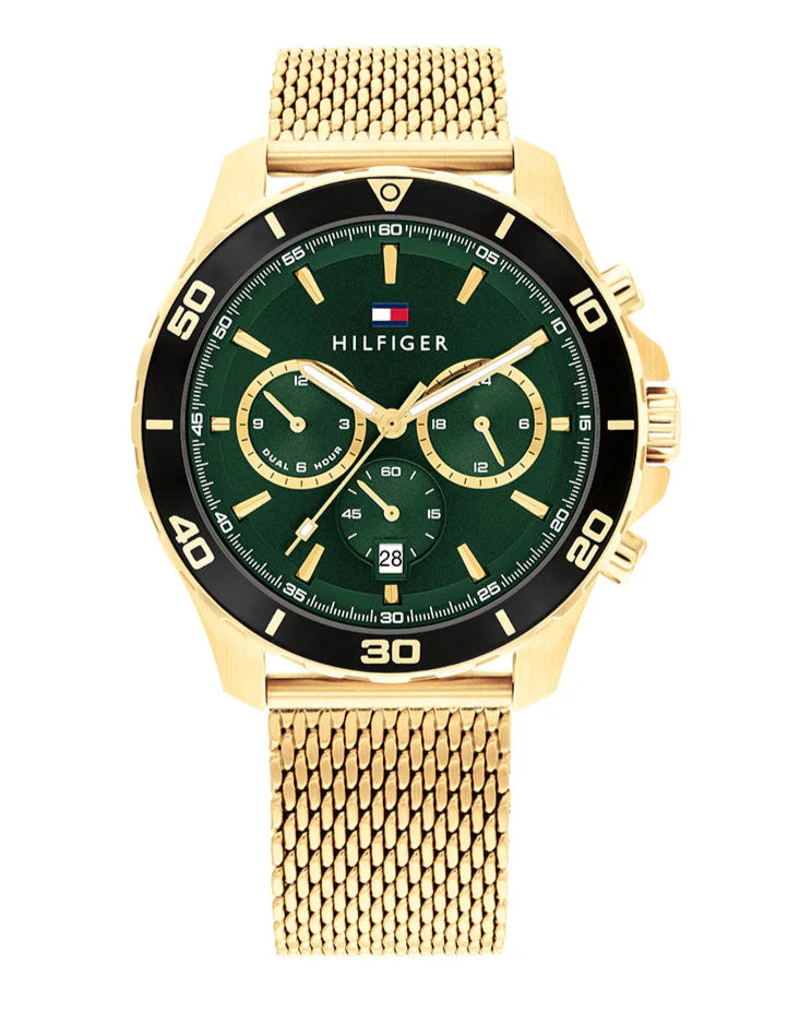 Tommy Hilfiger watch with gold mesh band and green dial on a white background